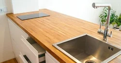 Sink on a wooden countertop in the kitchen photo