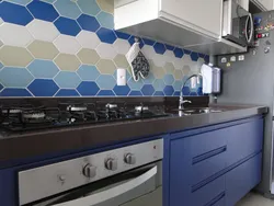 Apron for a blue kitchen made of tiles photo
