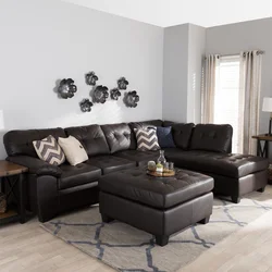 Dark sofa in the interior of a bright living room