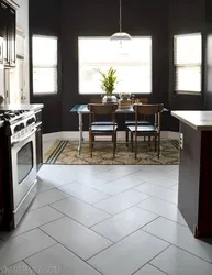 Brown tiles on the floor in the kitchen interior