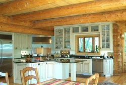 Photo Of A White Kitchen In A Wooden House