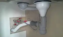 Pipe under the sink in the kitchen photo