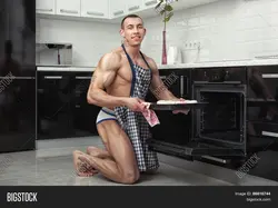 Men in an apron in the kitchen photo