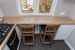 Wide window sill in the kitchen design