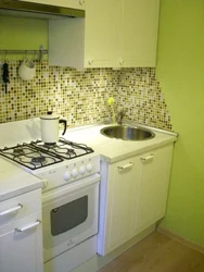 Kitchen with a regular stove photo