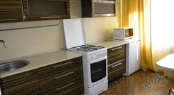 Kitchen with a regular stove photo