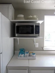Microwave in the kitchen on the window photo
