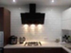 White kitchen with black stove photo