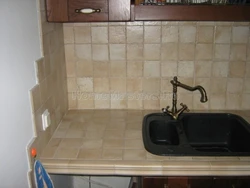 Sink against the kitchen wall photo