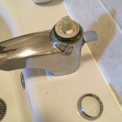 Photo of a disassembled faucet with bathtub