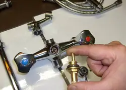 Photo of a disassembled faucet with bathtub