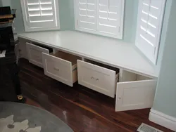 Cabinet by the window in the kitchen photo