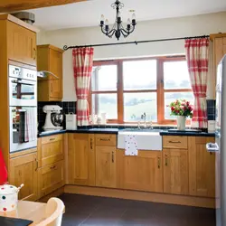 Kitchen in a wooden house with a sink by the window photo