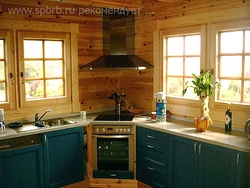 Kitchen in a wooden house with a sink by the window photo