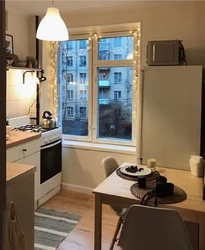 Design of a one-room apartment kitchen by the window