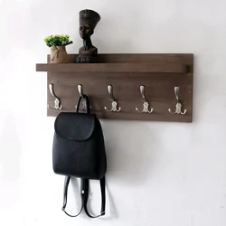 Photo of wall-mounted wooden clothes hangers in the hallway