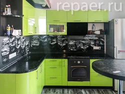 Photo of black and light green kitchen