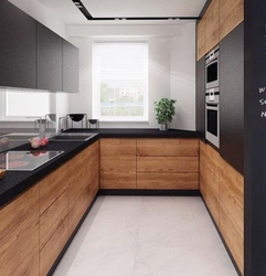 Black and white kitchen with wooden countertop photo