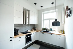 Black and white kitchen with wooden countertop photo