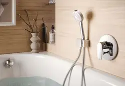 Bathroom faucet with shower built into the bathtub photo