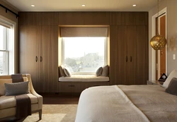 Photo of a bedroom in a house with one window in a modern style
