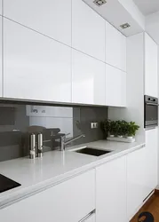 Gray white kitchen with black countertop photo