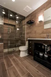 Bathroom design with dark tiles and wood