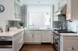 U-shaped kitchen with sink by the window photo