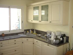 Corner kitchen design with sink by the window