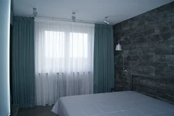 Curtains in a gray and white bedroom interior