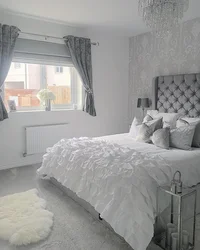 Curtains in a gray and white bedroom interior