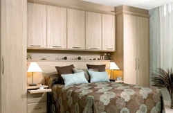 Bedroom design with two wardrobes next to the bed