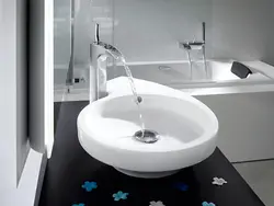 Sink and bathtub with one faucet photo