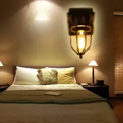 Sconce on the wall in the bedroom above the bed photo