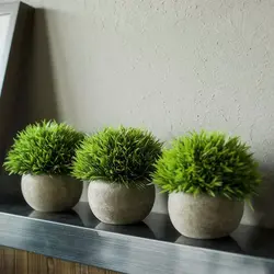 Artificial flowers in pots in the kitchen interior