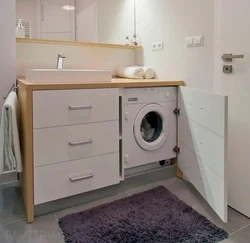 Bathroom cabinet with sink and washing machine photo