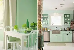 Combination of green color in the interior of the kitchen and living room