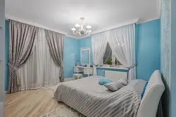 Curtains in the bedroom interior with blue wallpaper