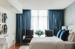 Curtains in the bedroom interior with blue wallpaper