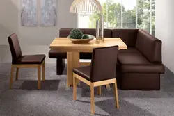 Photo of a kitchen with a sofa and table chairs