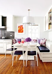 Photo of a kitchen with a sofa and table chairs