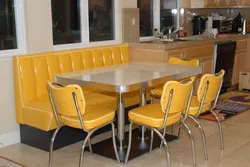 Photo of a kitchen with a sofa and table chairs