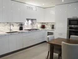 Kitchen design with marble countertops and splashback