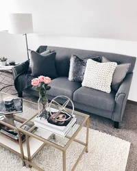 Gray sofa with pillows in the living room interior