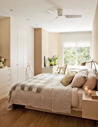 Interior of a small beige bedroom