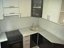 Corner kitchens with a sink in the corner and a refrigerator photo