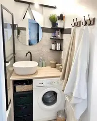 Interior of a small bath with sink and washing machine