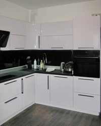 White glossy kitchen with black countertop photo