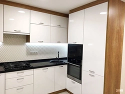 White glossy kitchen with black countertop photo