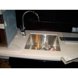 Sink built into the countertop for the kitchen photo